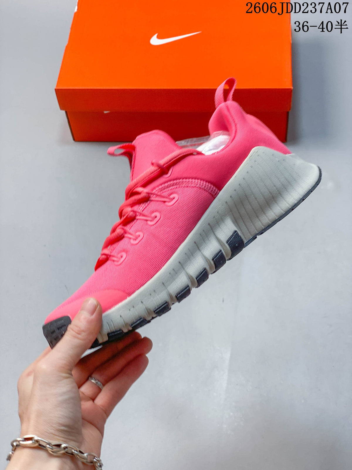 Side view of a pink lace-up shoe with a segmented light-colored sole.