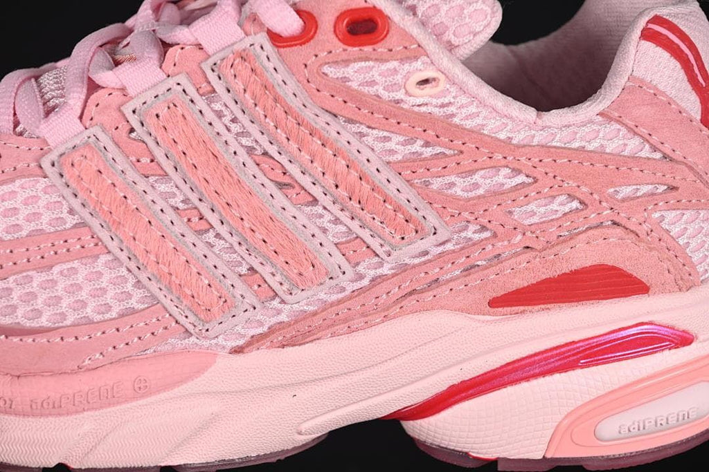 Close-up of mesh panels, layered stripes, and red accents.
