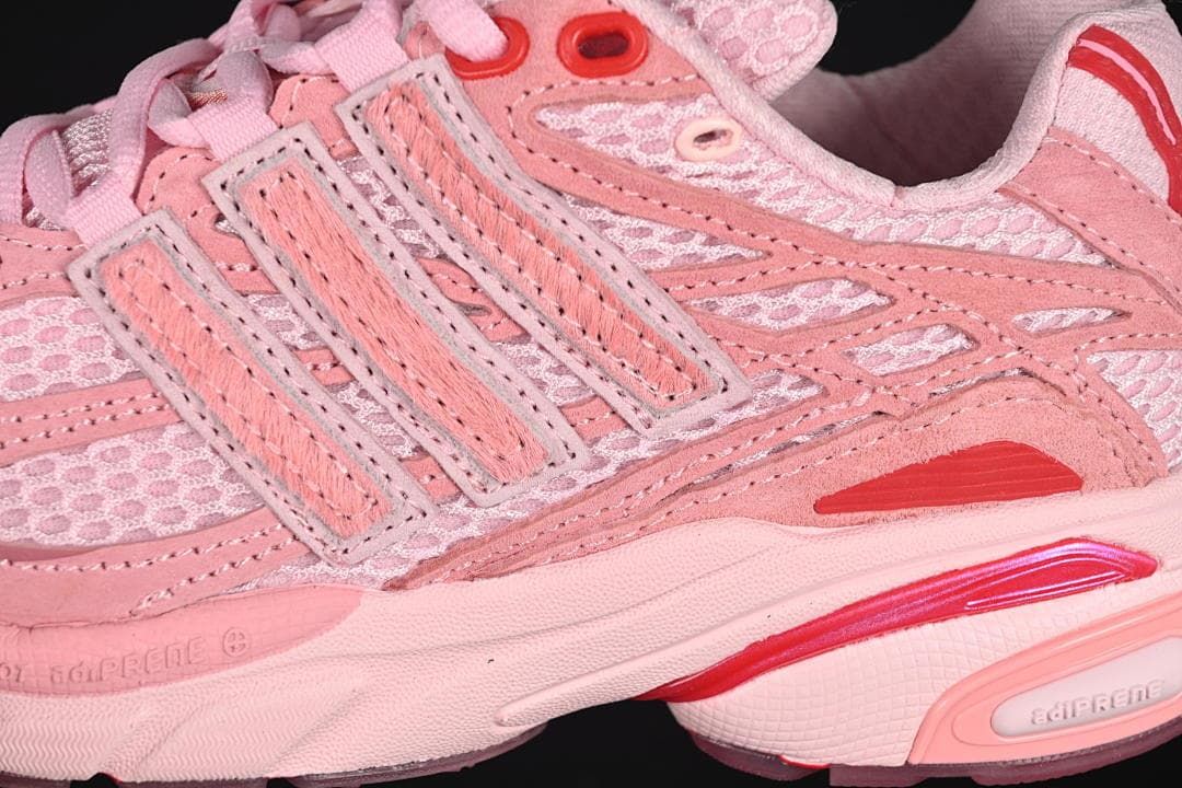 Close-up of mesh panels, layered stripes, and red accents.