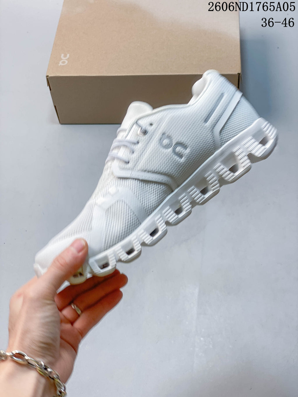 Side view of a white On Cloud 5 sneaker showing the mesh-look upper and segmented sole