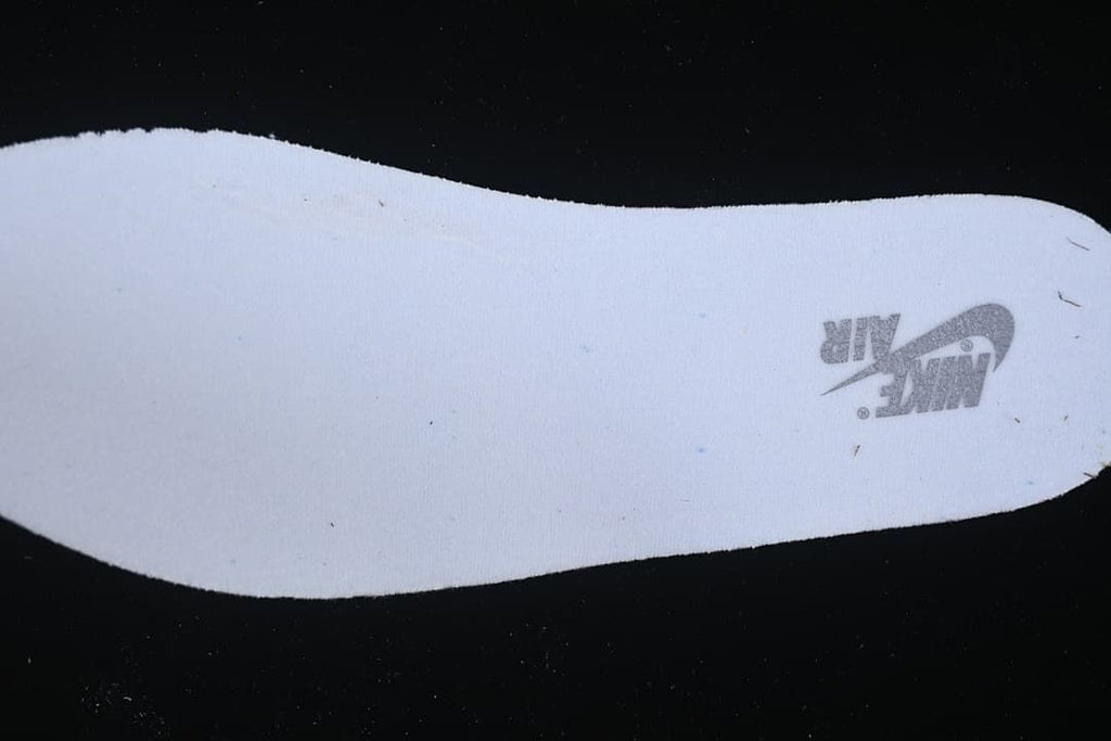 Close-up of a white shoe insert with a printed Nike Air mark.