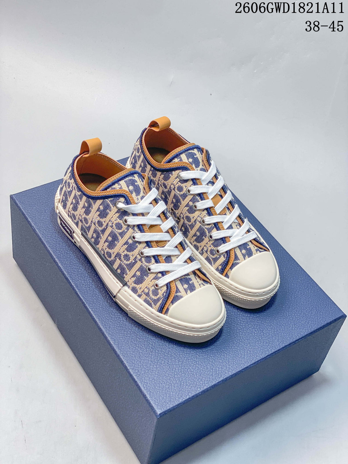 Pair of blue and beige patterned low-top sneakers with white laces, cream-colored soles, and tan trim
