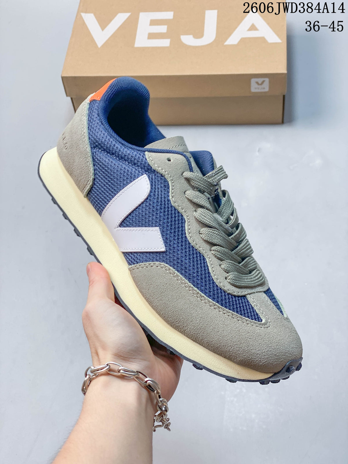 Navy and gray Veja sneaker with a pale side logo, cream-colored midsole, and dark outsole.