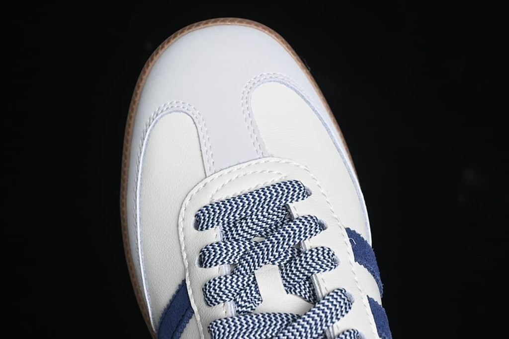 Top view of the sneaker's white toe and navy-and-white patterned laces.