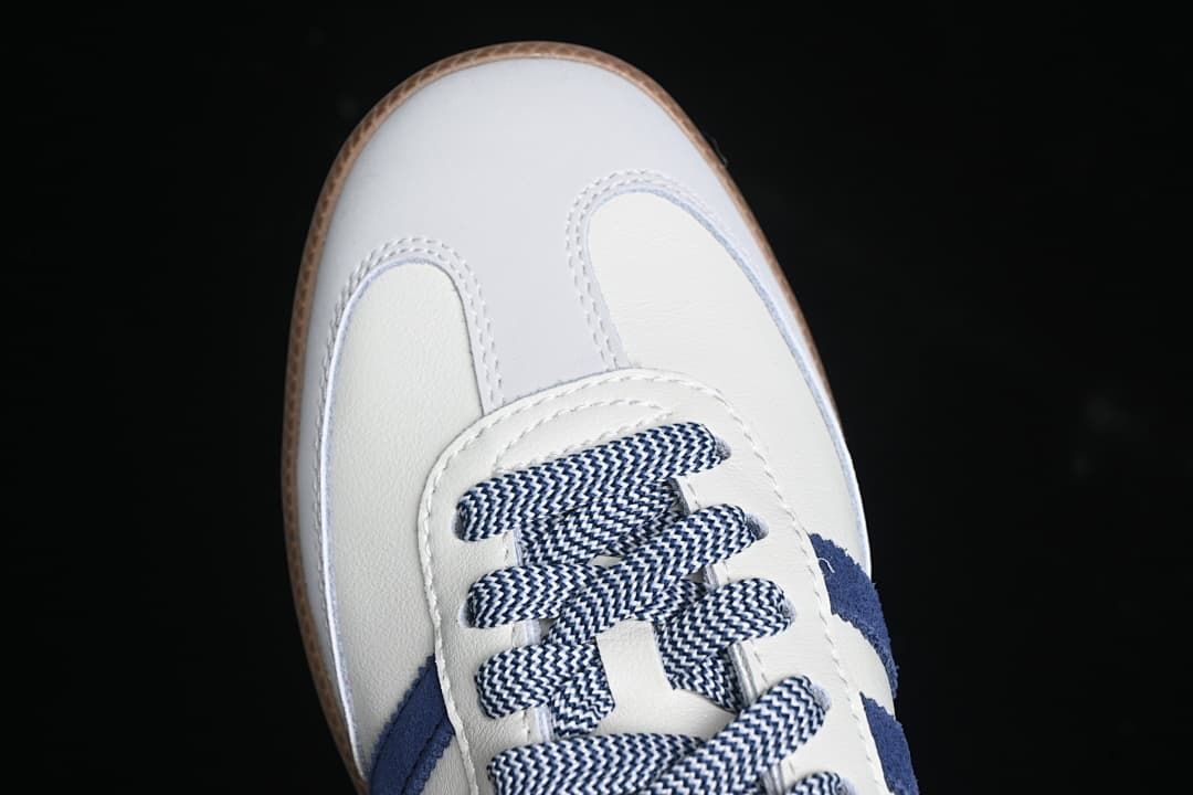 Top view of the sneaker's white toe and navy-and-white patterned laces.