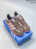 Pair of brown and pink adidas Sambae low-top platform sneakers displayed on a blue shoebox