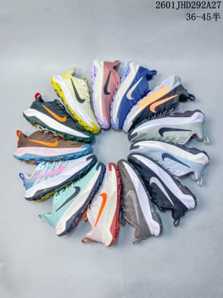 Several Nike trail running shoes arranged in a circular display in varied colorways.
