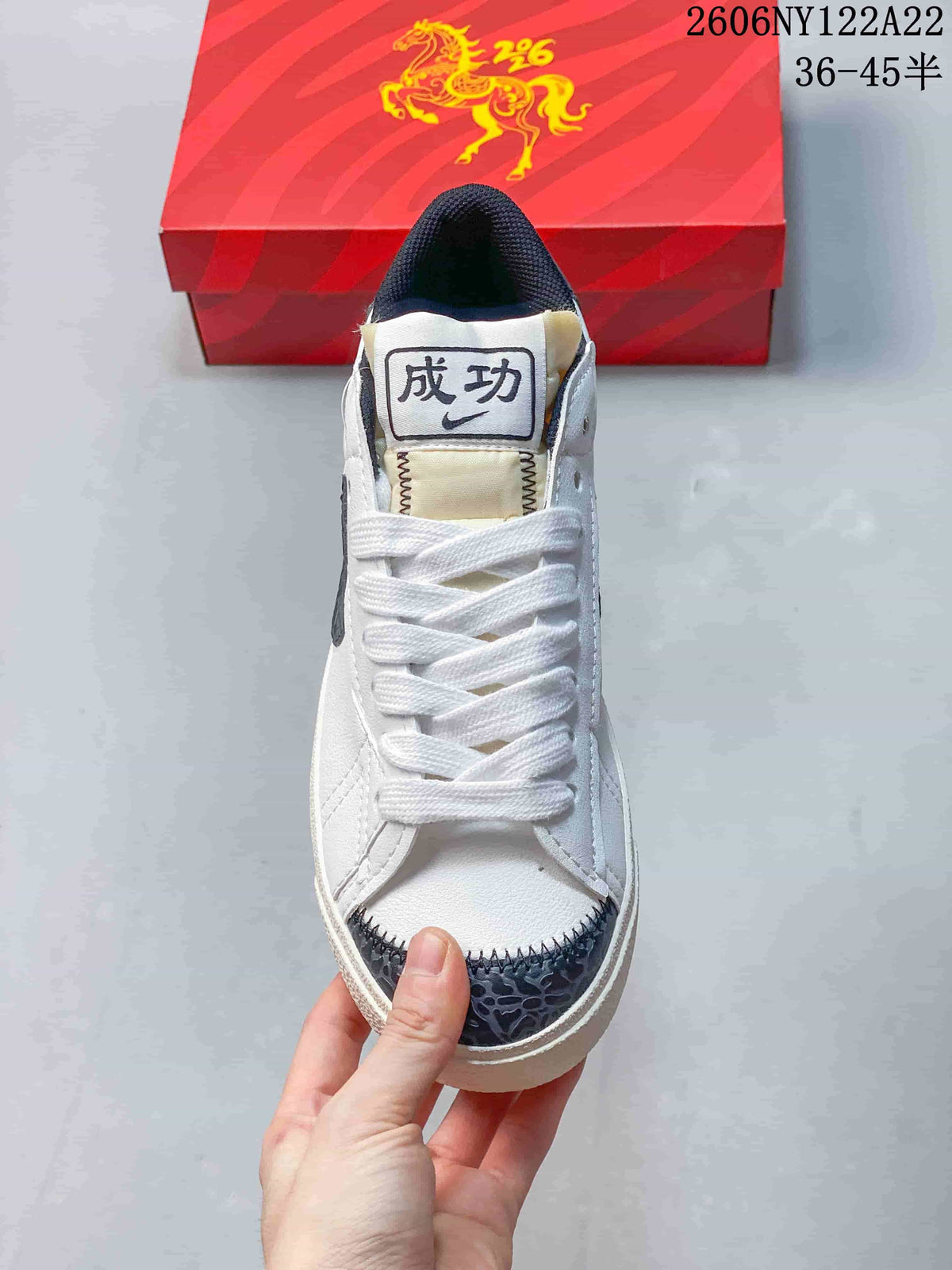 Front view showing white laces and a dark gray patterned toe overlay.