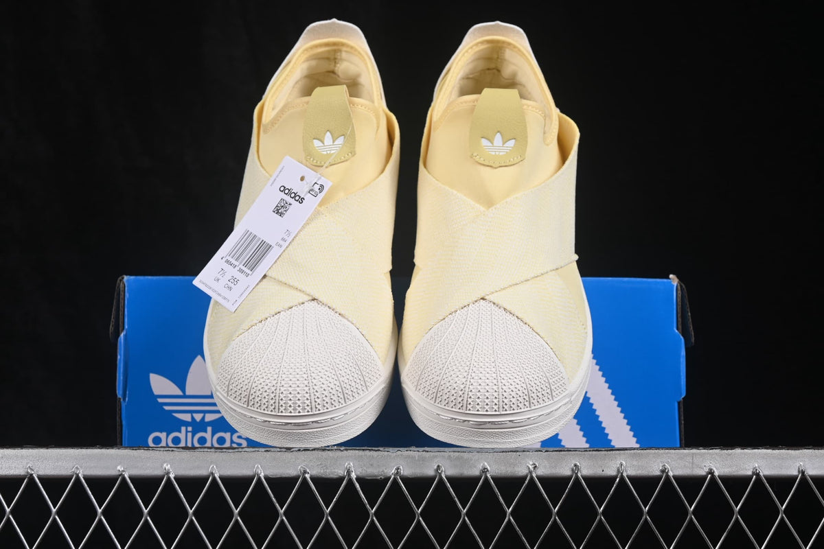 Front view of the pair displayed on an adidas shoe box.