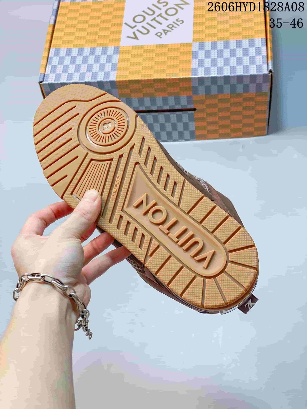 Underside of a Louis Vuitton Trainer sneaker showing a gum-colored molded outsole