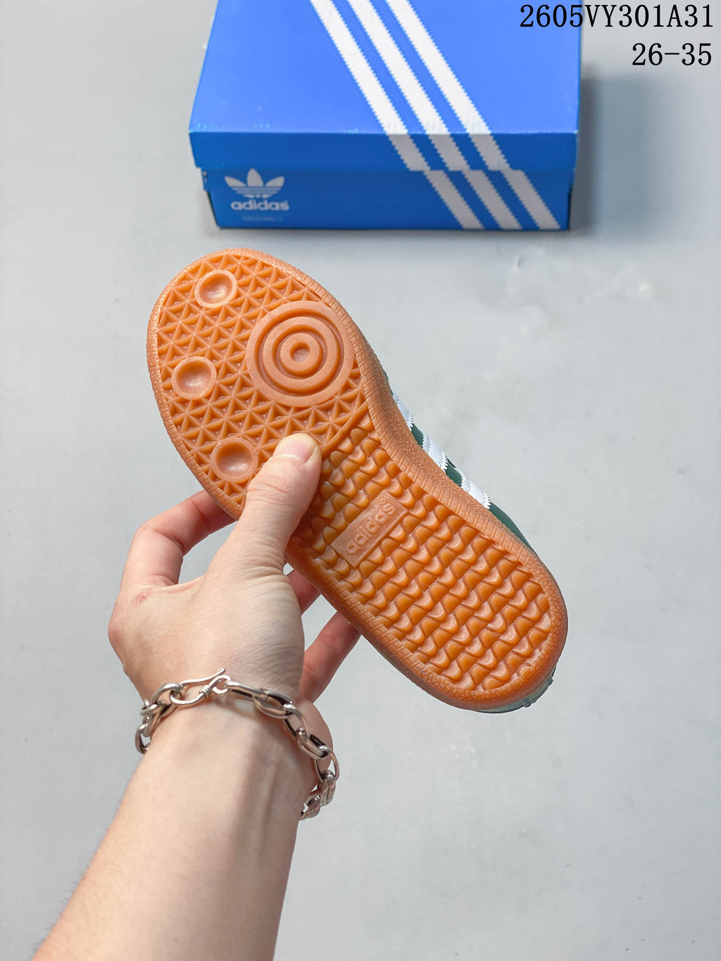 Underside of a kids' shoe showing a patterned gum-colored outsole