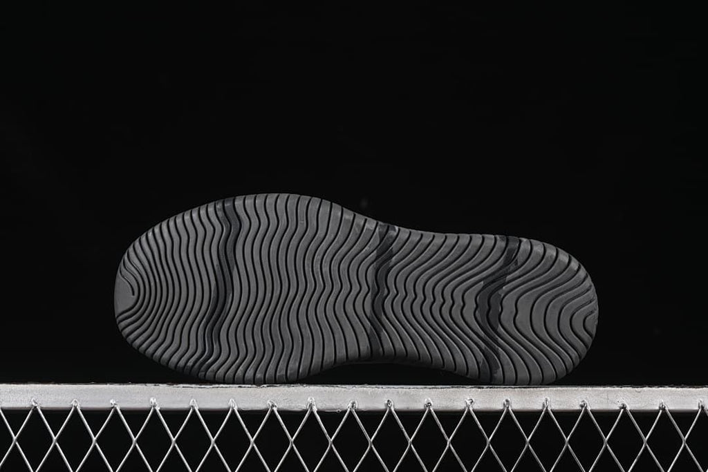 Underside view of the outsole with wavy grooves