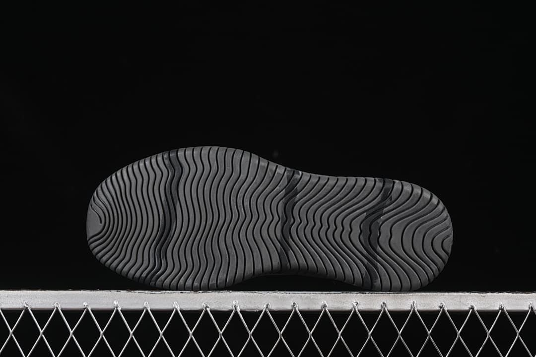 Underside view of the outsole with wavy grooves