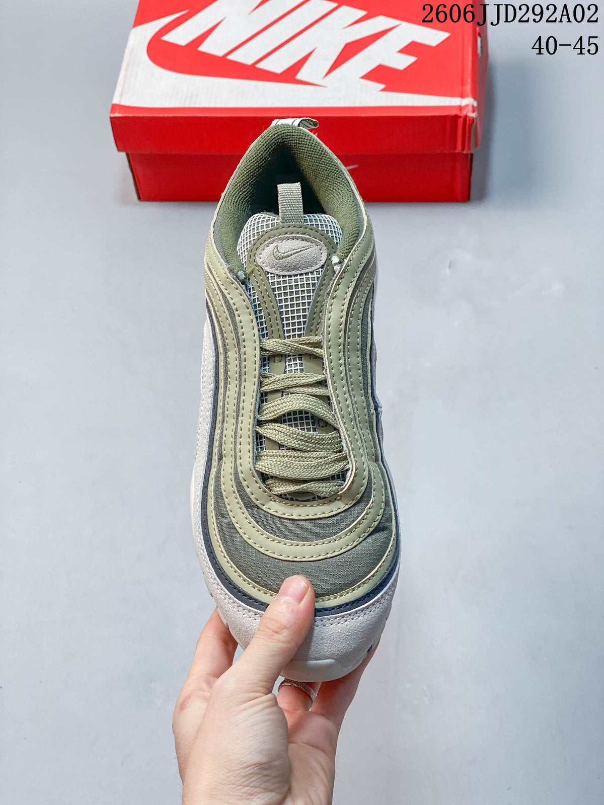 Top view of a Nike Air Max 97 sneaker showing its laces, mesh tongue, and layered upper