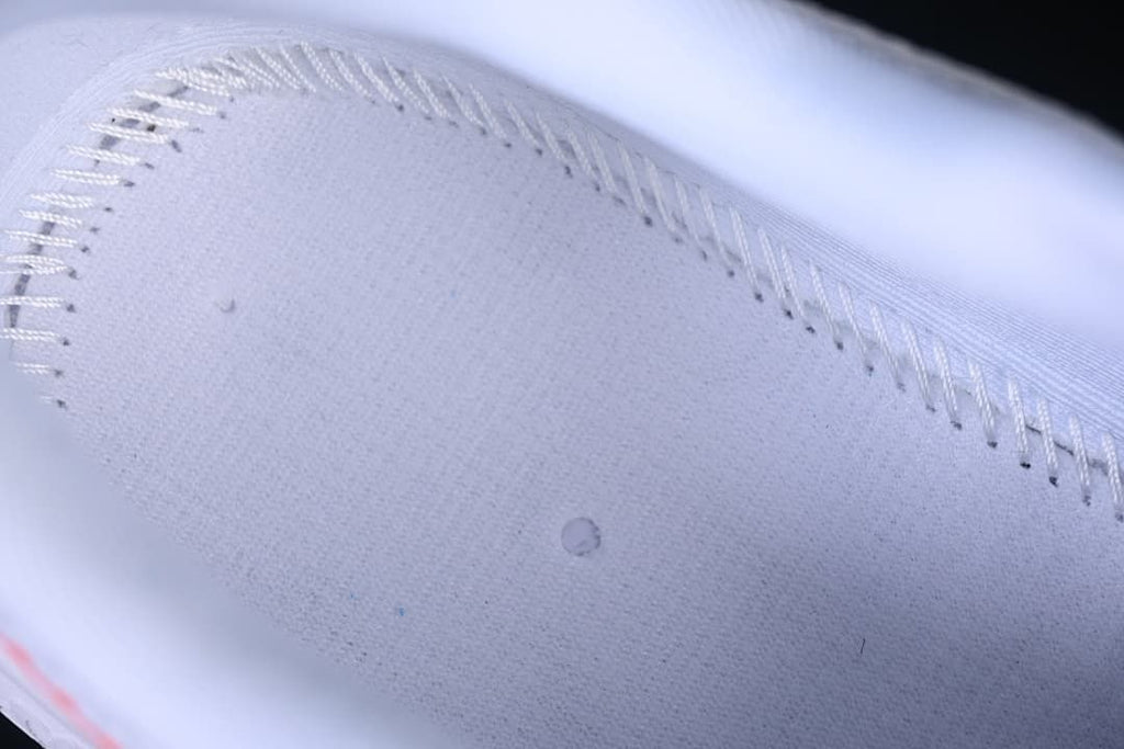 Close-up detail of the white textured upper and stitching