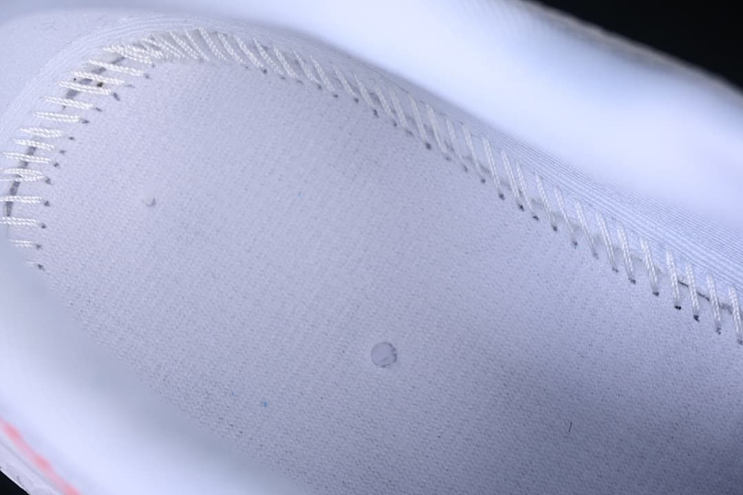 Close-up detail of the white textured upper and stitching