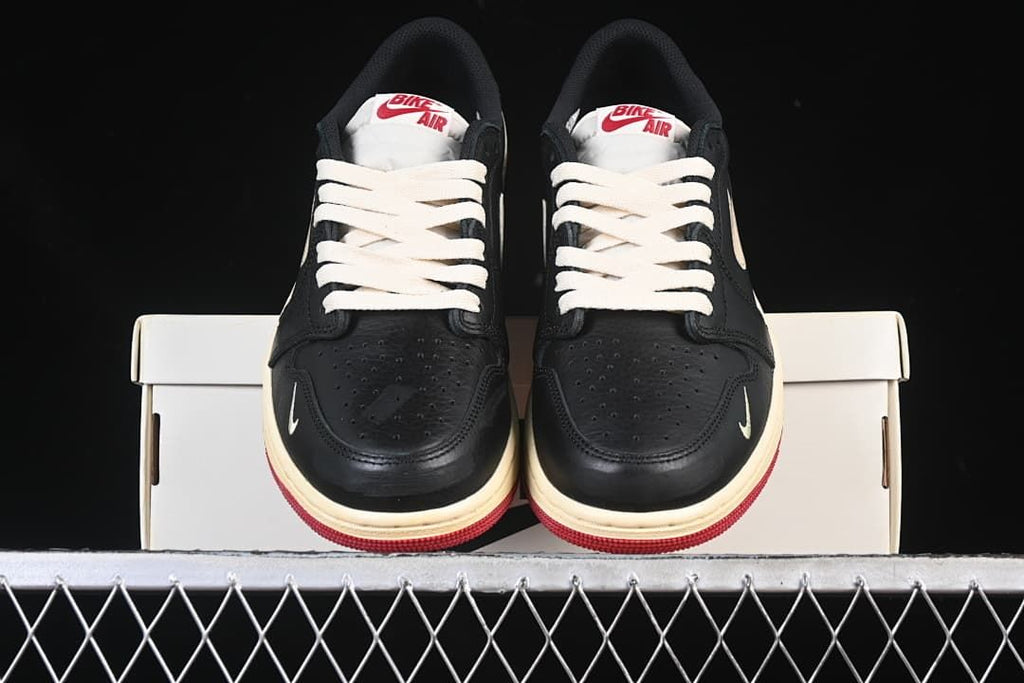 Front view of the pair showing perforated toes, cream laces and red outsoles