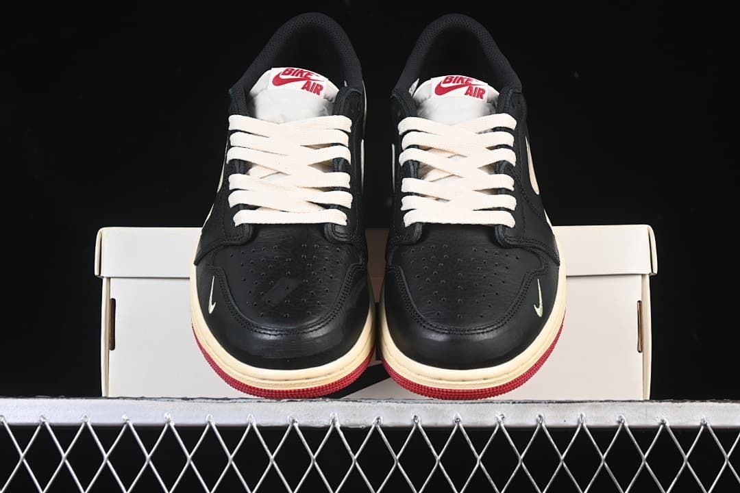 Front view of the pair showing perforated toes, cream laces and red outsoles