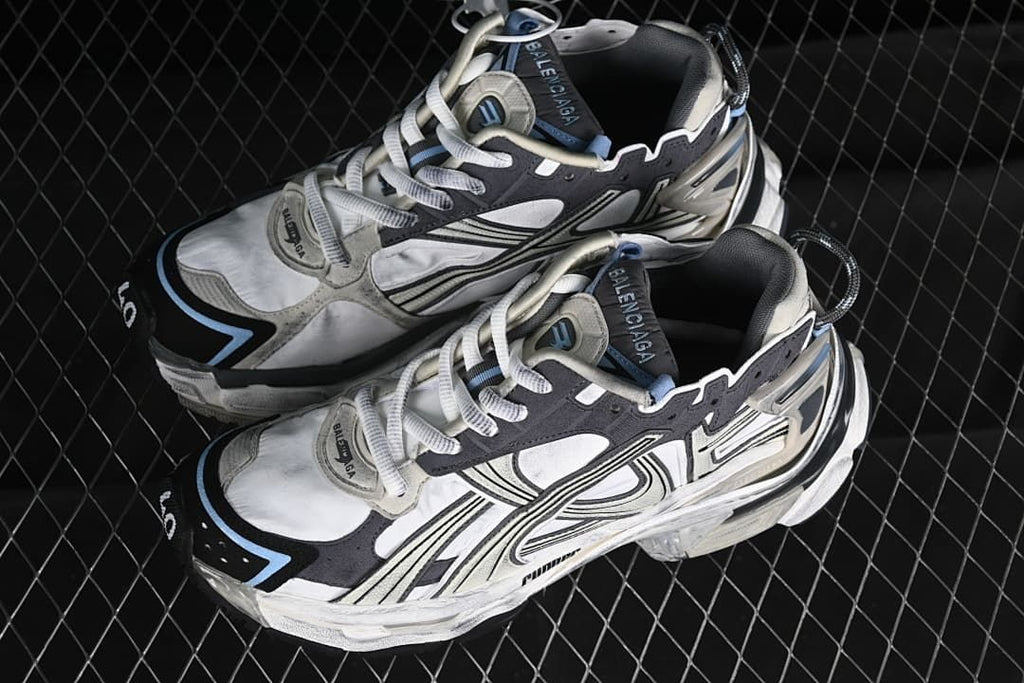 Pair of beige, white and charcoal Balenciaga Runner sneakers viewed from above and the front.