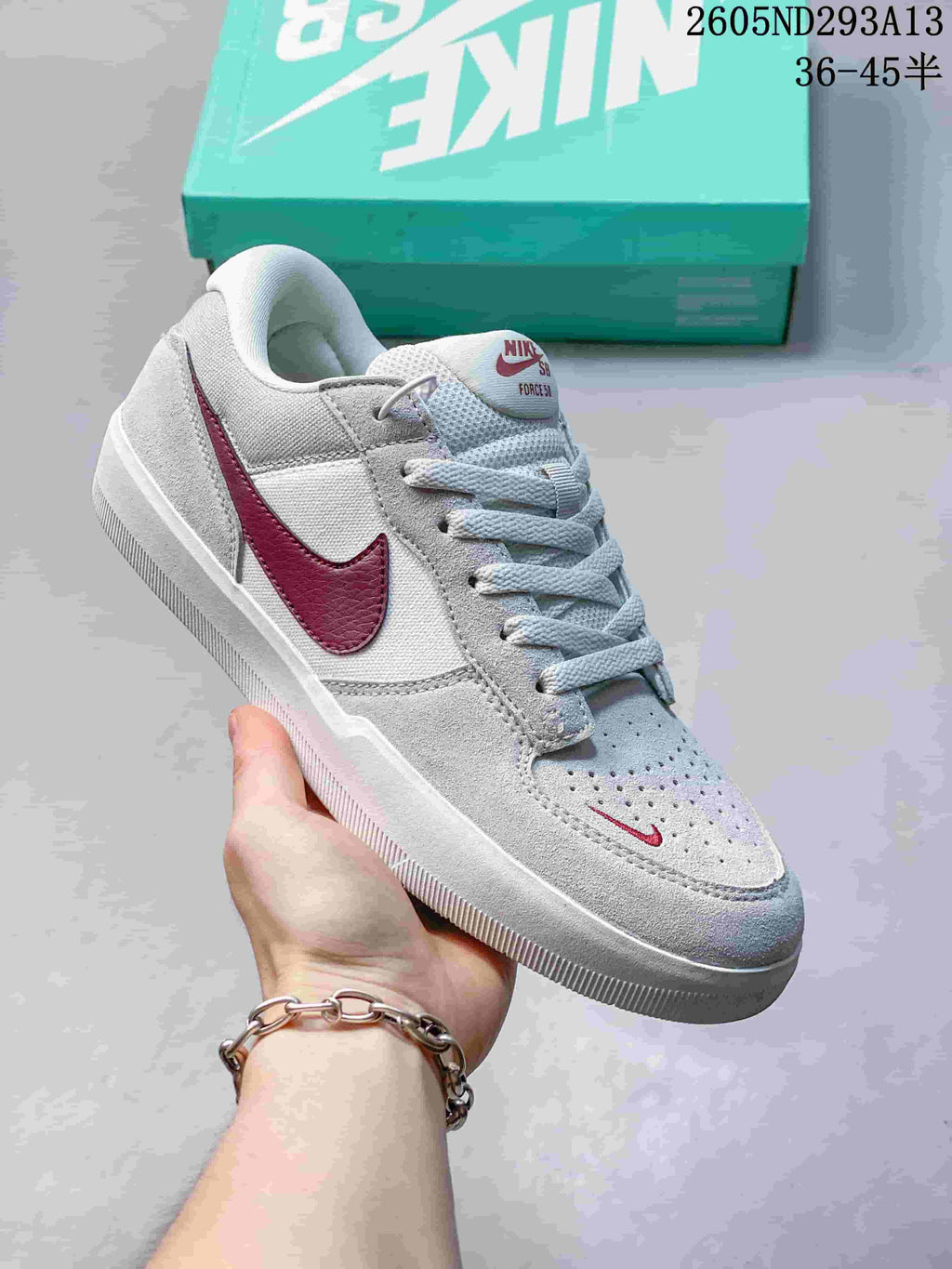 Light grey Nike SB Force 58 sneaker with a burgundy Swoosh