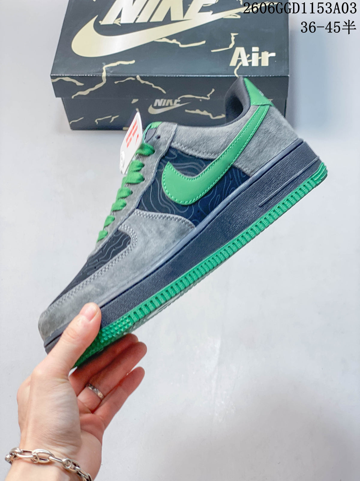 Side view showing gray and navy panels, green accents, and patterned detailing