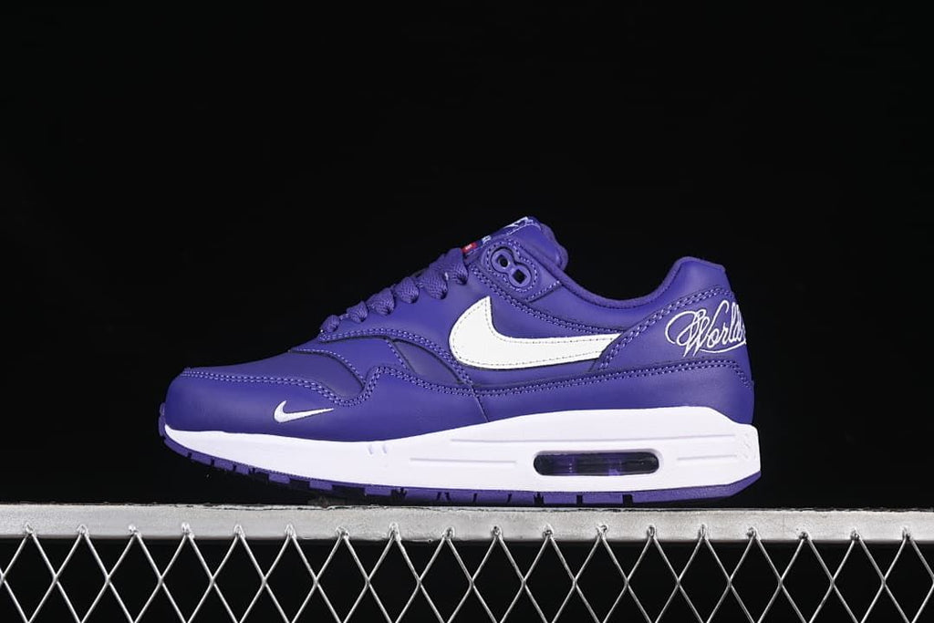 Side view of a purple Nike Air Max 1 sneaker with white Swoosh and visible Air unit