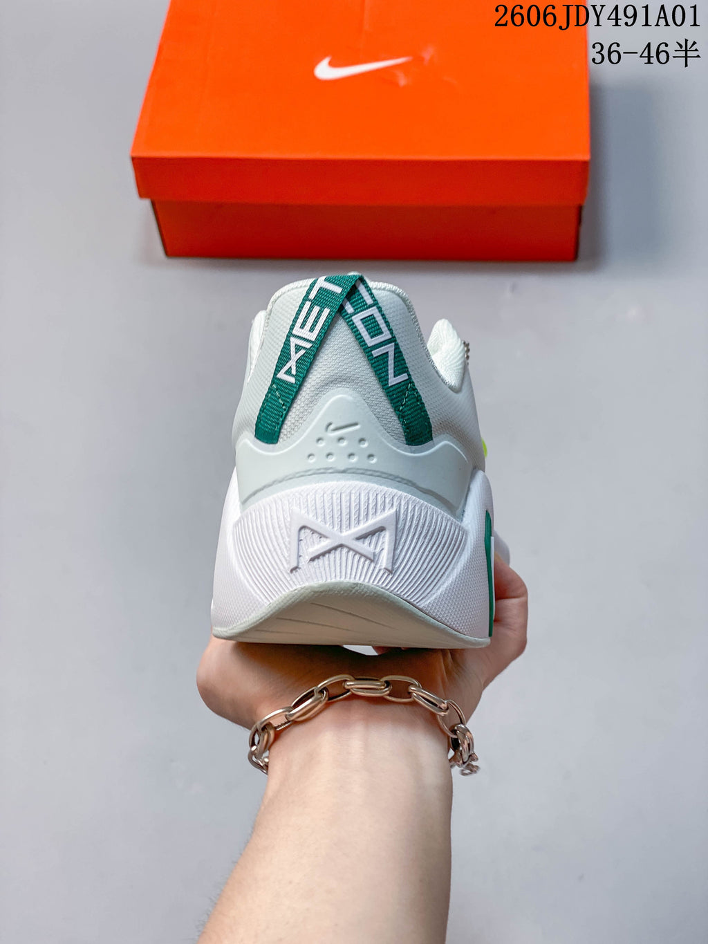 Rear view of the shoe showing its heel and green pull tab.