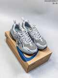 Pair of silver and gray ASICS GEL-1090 sneakers displayed on a shoebox