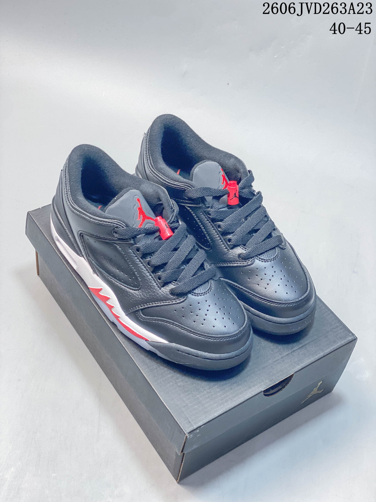 Pair of dark gray Jordan Sixty Plus Low shoes with red accents, shown from above.
