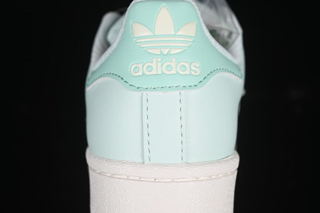 Rear view of the mint green sneaker with adidas branding
