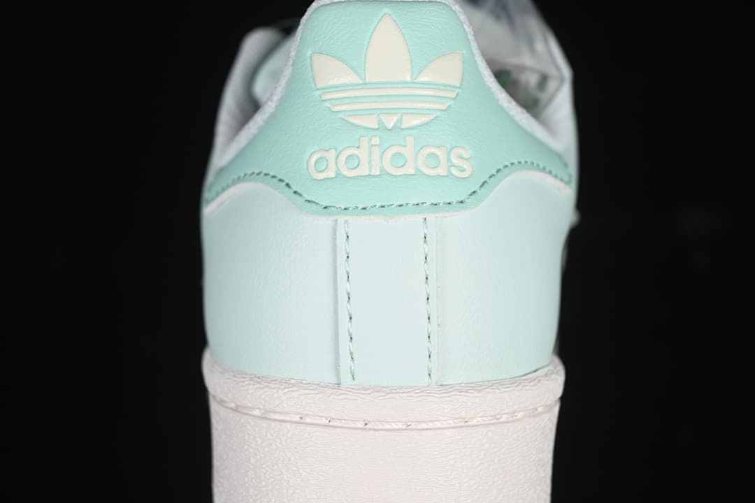 Rear view of the mint green sneaker with adidas branding