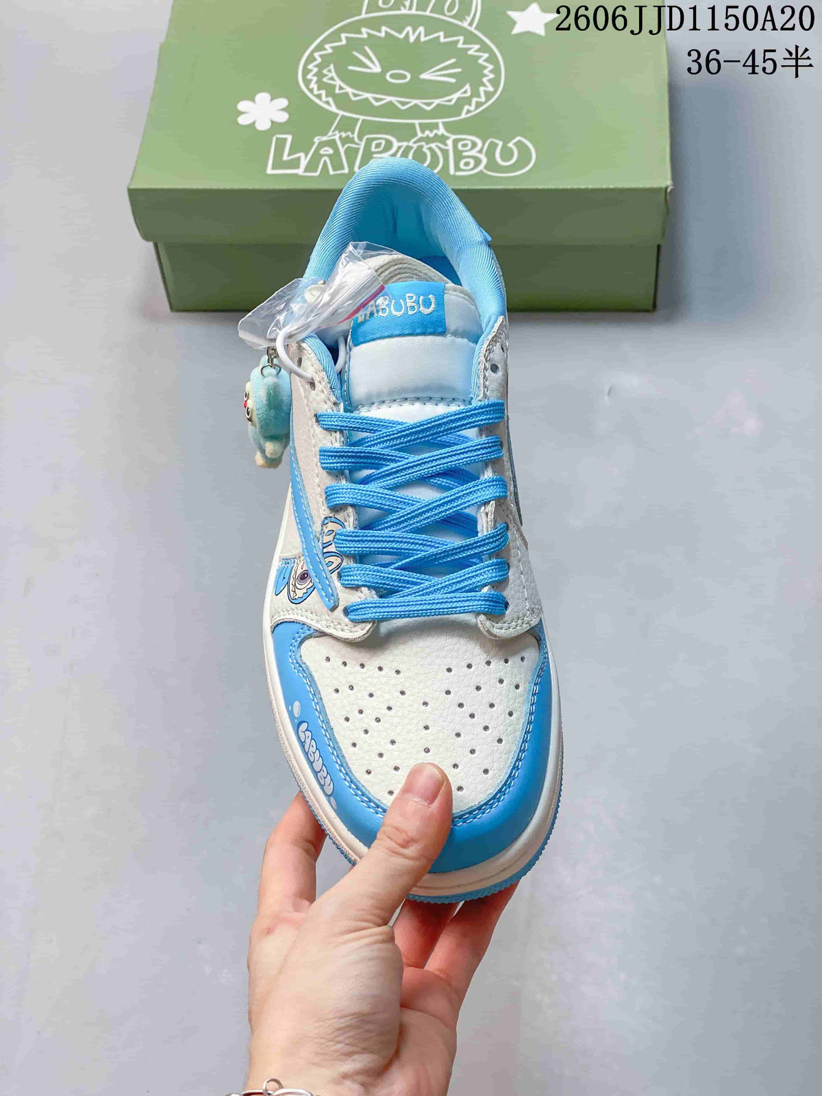 Top view of the sneaker showing its perforated toe, blue laces, and character details.