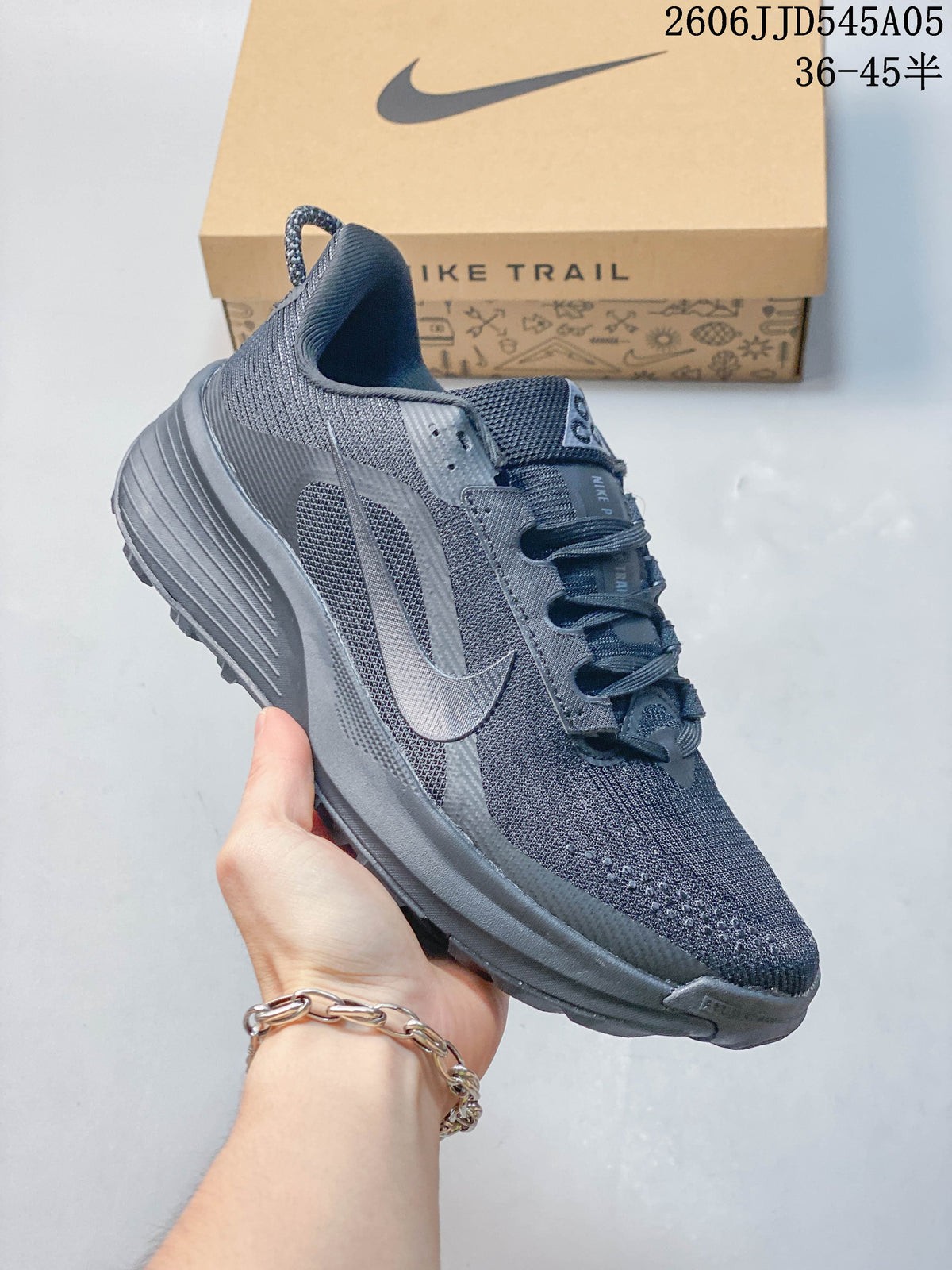 Side view of a gray Nike Pegasus Trail 6 shoe displayed with its box