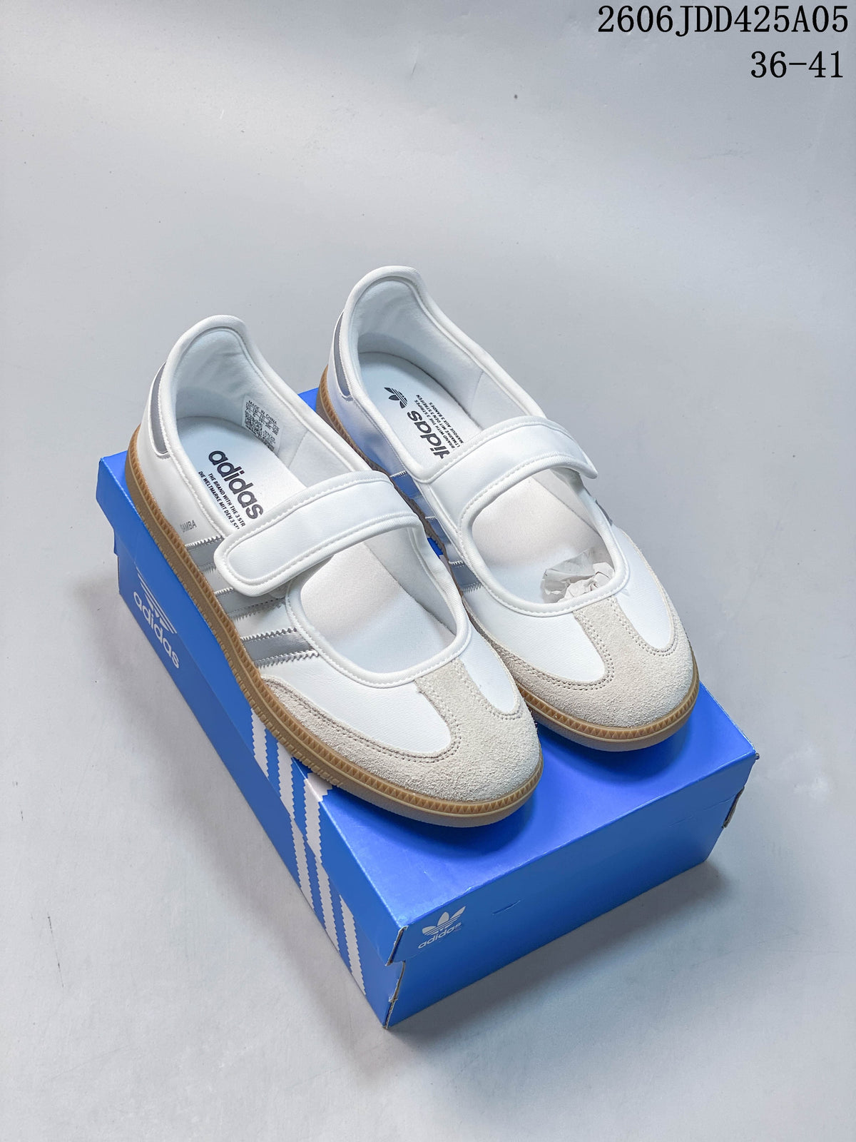 Pair of white Adidas Samba OG strap sneakers on a blue shoe box