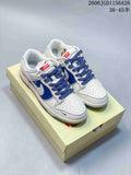 White and blue low-top Dunk-style sneakers with patterned side panels and blue laces