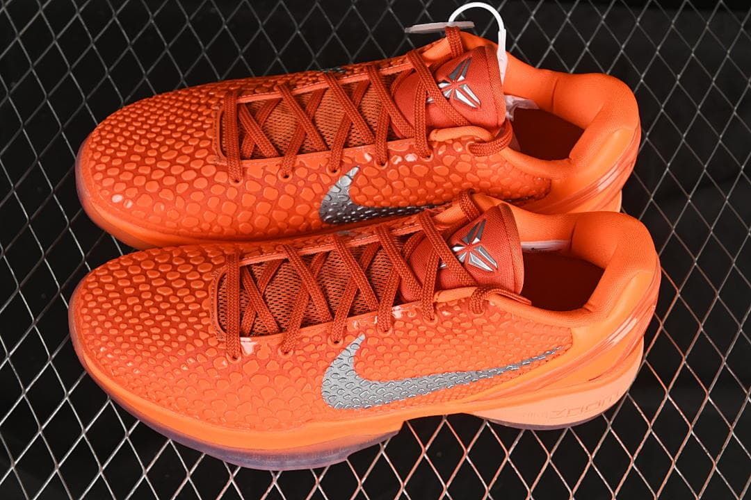 Pair of orange Nike Kobe VI Protro shoes shown from above