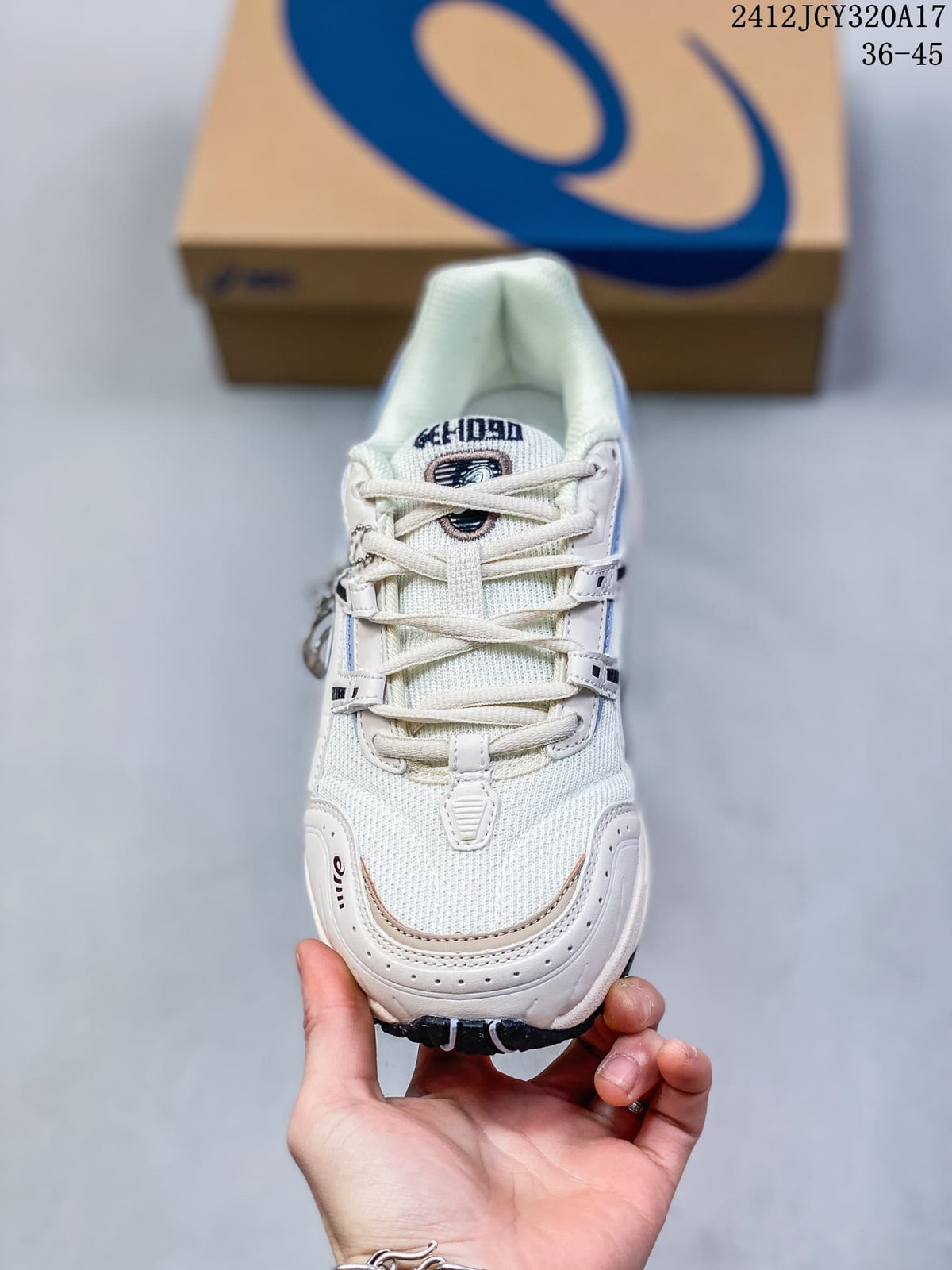 Top view of a white and blue ASICS GEL-1090 sneaker showing its laces and layered upper; image shows size range 36–45.
