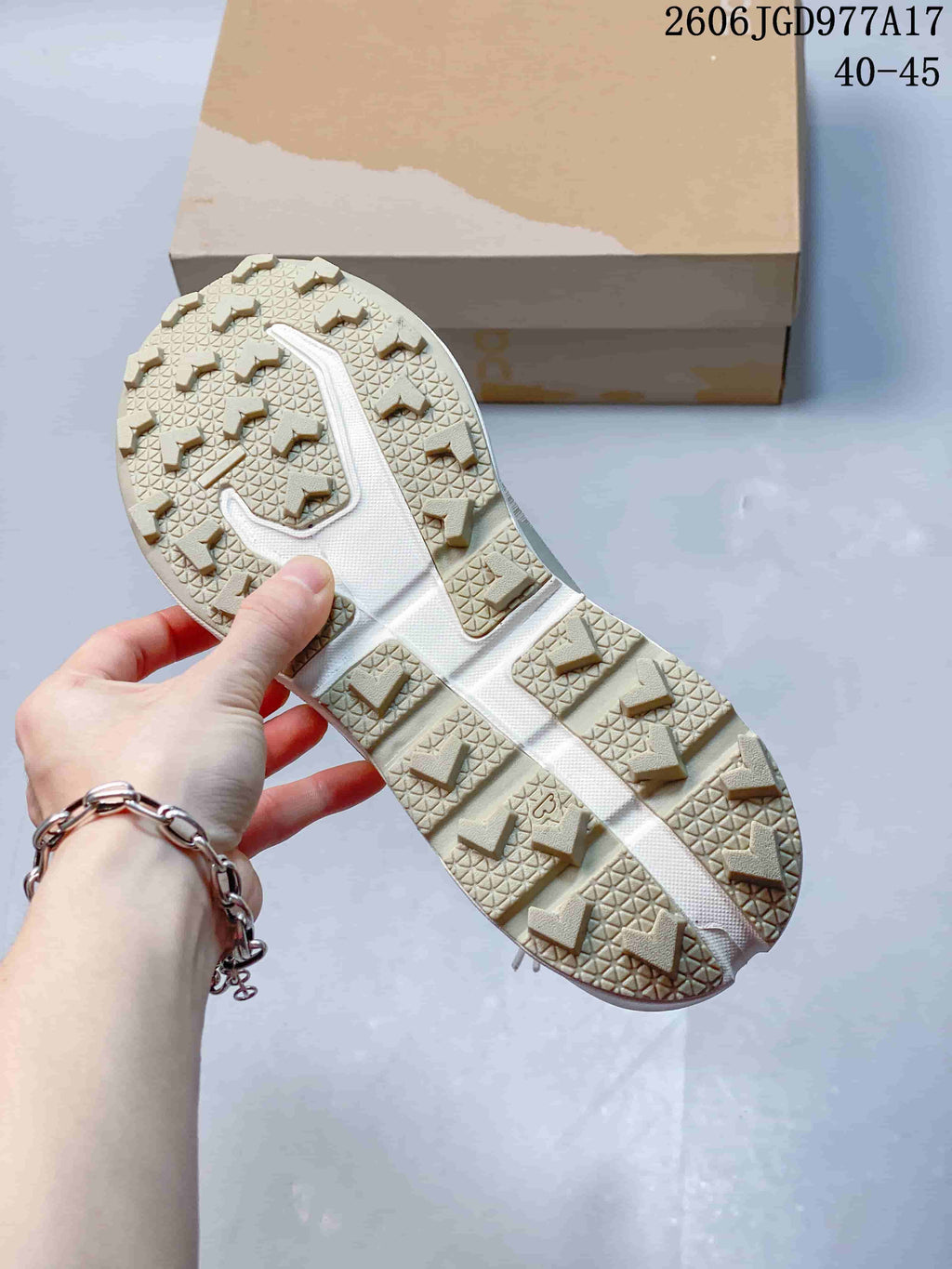 Close-up of the shoe's lugged outsole and angular tread.