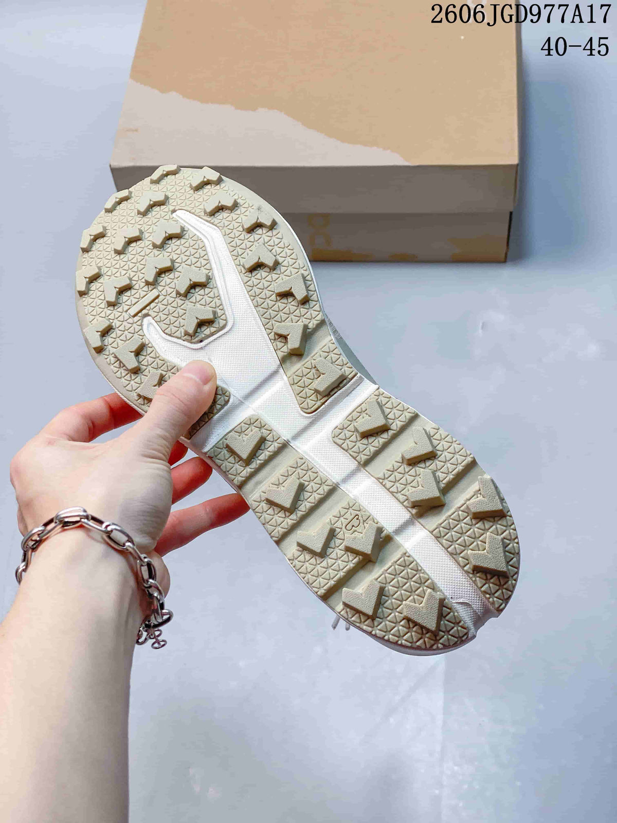 Close-up of the shoe's lugged outsole and angular tread.