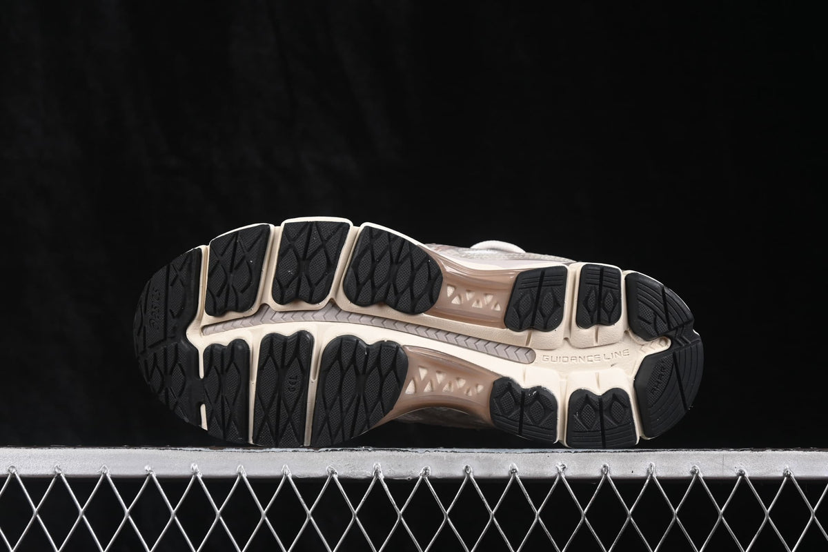 Outsole view showing the segmented black traction sections and cream midsole structure.