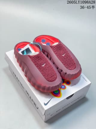 Pair of red Nike Mind 001 slip-on mules displayed on the box.