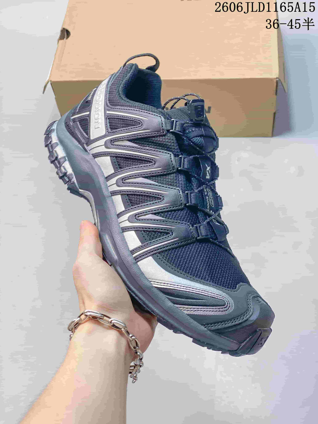 Side view of the charcoal gray shoe showing its upper, overlays, and tread; image overlay lists sizes 36–45.5.