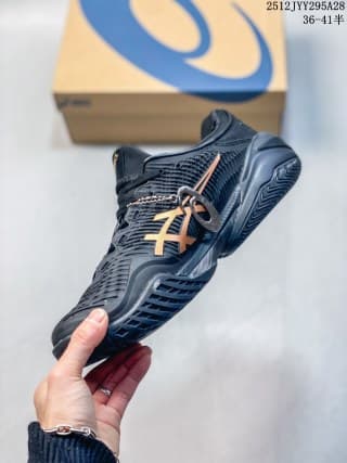 Angled side view of the navy and orange ASICS sneaker highlighting the lacing system, side branding, and sole profile.