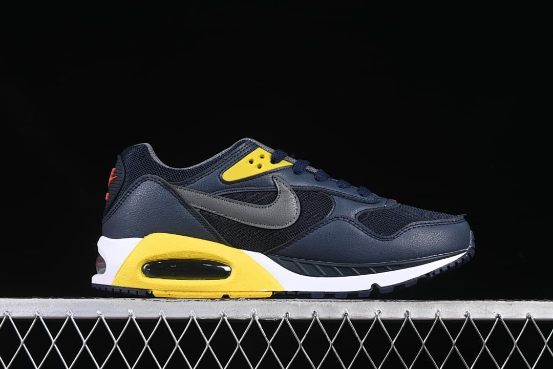 Side profile of the sneaker highlighting the gray Swoosh and yellow heel section.