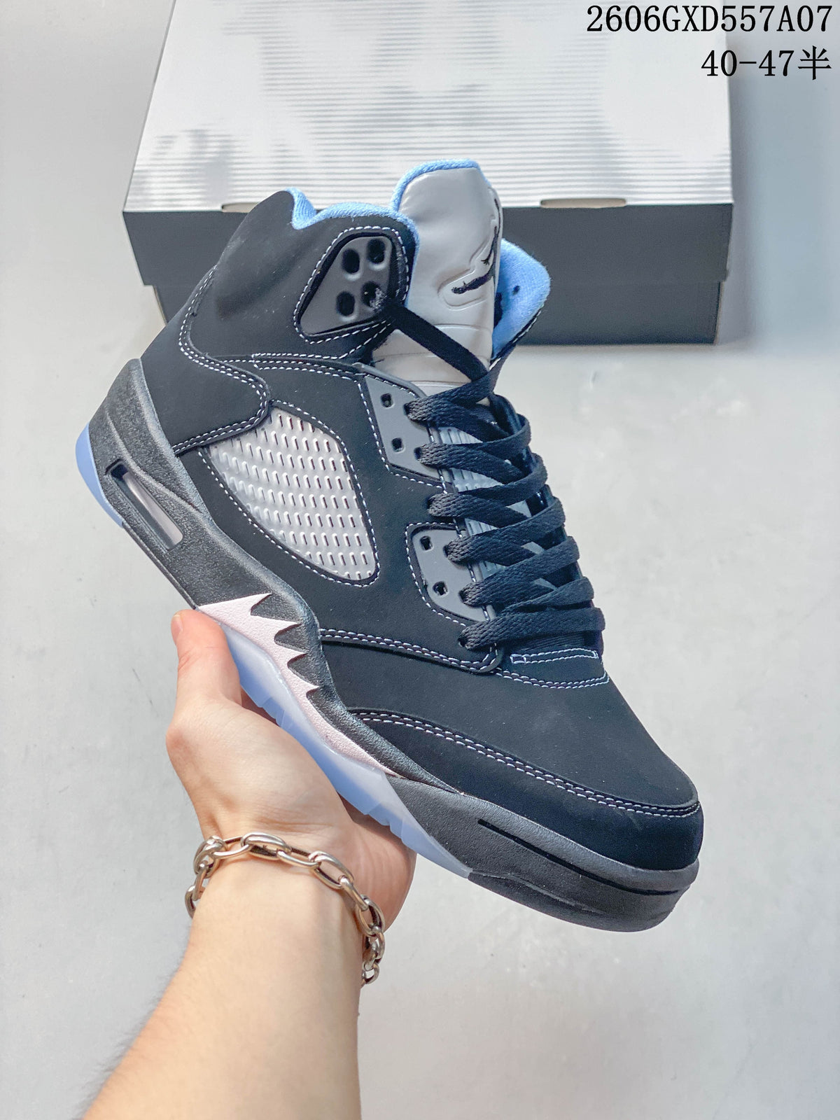 Angled side view of a Jordan Air Jordan 5 high-top sneaker with dark overlays, mesh side panel, and light blue sole accents.