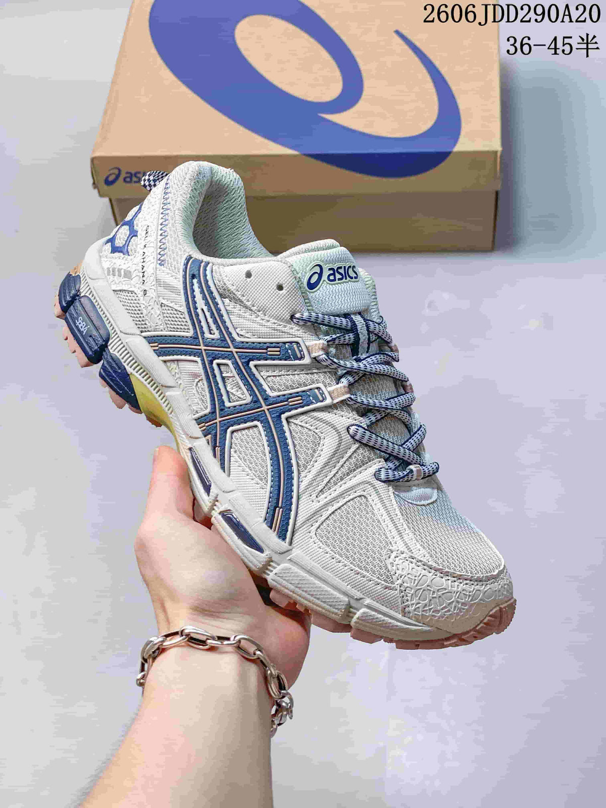 Close-up of a white ASICS Gel-Kahana 8 sneaker with navy accents.
