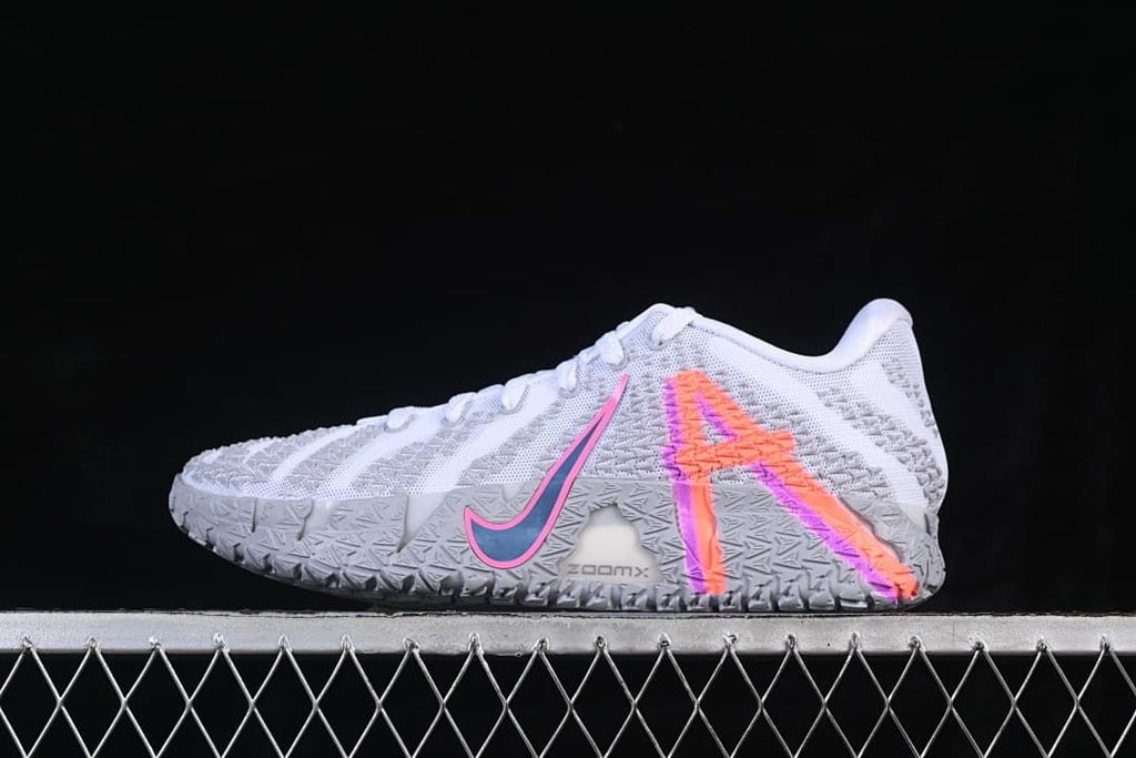 Side view of white and grey Nike Ja 3 EP basketball shoes with bright orange and pink accents