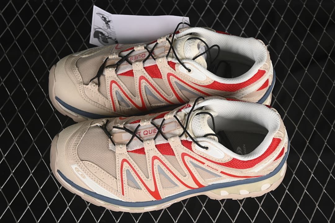 Pair of beige and red Salomon XT-Quest sneakers shown from above