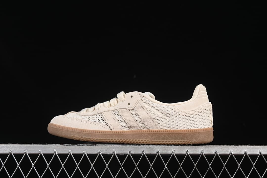 Side view of a cream adidas Samba OG sneaker with openwork panels and a gum-tone sole.