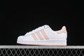 Side view of white adidas Superstar JH7056 sneakers with blush-pink stripes and heel accent.